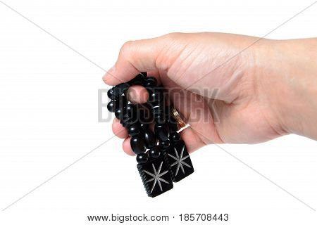 Rosary in hand on a white background isolated.