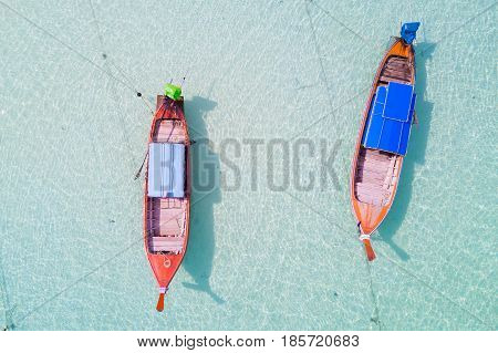 Aerial view over group of long tail boatsTop view from drone Koh Lipe island SatunThailand.