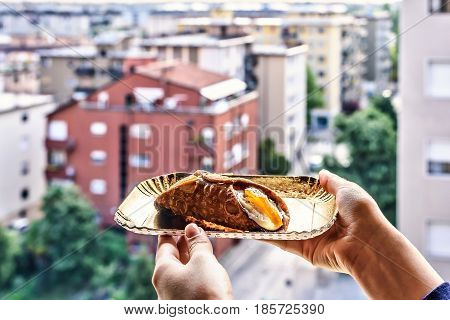 Tasty Cannoli italian special dessert. city background