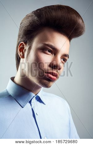 Side view of young man with retro classic pompadour hairstyle. studio shot.