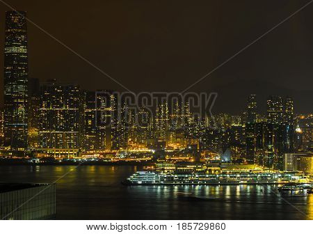 Harbor atmosphere and Hong Kong business district at night time.