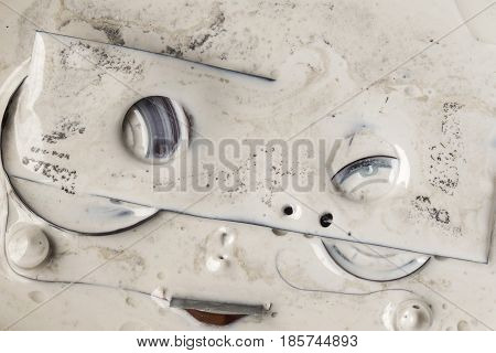 melted plastic grey cassette tape in paint thinner