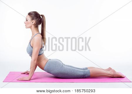 girl doing yoga on white background. woman Doing exercises on Mat