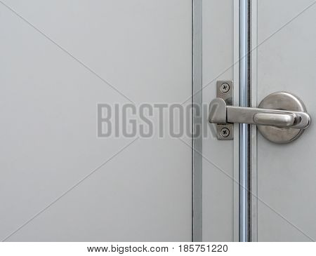 Metal lock latch with the copy space for lock the toilet door in the public toilet.