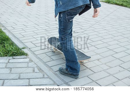 inexperienced kid learns to ride a skateboard. newbie