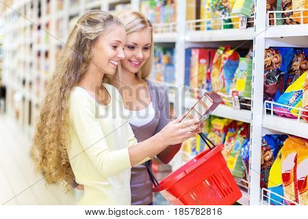 Portrait of Two Women Reading a Lable in a Supermarket