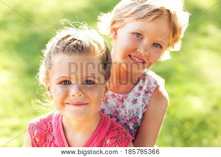 Child embracing childhood friends smiling friendship sisters