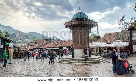SARAJEVO, BOSNIA AND HERZEGOVINA - May 1 2014: Bascarsija square with Sebilj wooden fountain in Old Town Sarajevo, capital city of Bosnia and Herzegovina