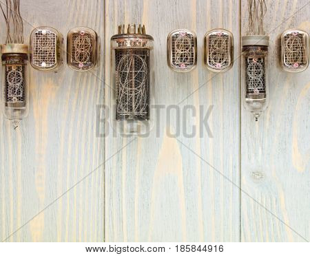 Top view of different nixie tubes on wooden planks.