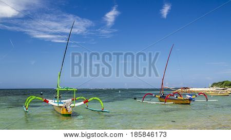two boats ready to sail in sanur bali during a summer day