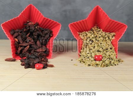 Hemp seeds and goji berries/ This is a hemp seeds and goji berries in red star bowls.