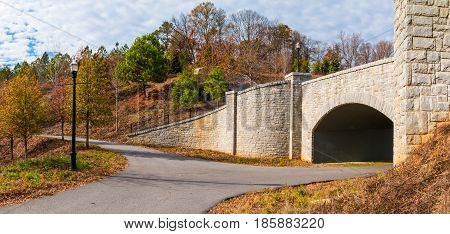 The Piedmont Park Trail and the stone bridge on the Evelyn St NE in autumn day Atlanta USA