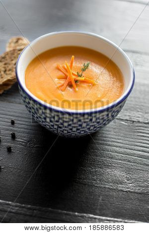 Carrot Soup Served In Bowl With Bread. Homemade Cream Carrot And Potato Pottage.