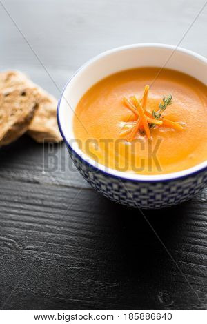 Carrot Soup Served In Bowl With Bread. Homemade Cream Carrot And Potato Pottage.