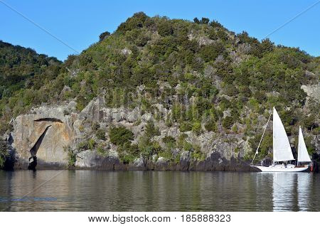 Sail Boat Near The Maori Rock Carving At Lake Taupo New Zealand