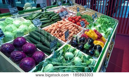 Greengrocery with shelf with fresh vegetables and fruits