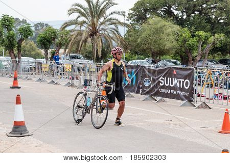 Nahariyya Israel - May 06 2017 : Participant of the annual triathlon finishes after a bicycle ride to Ahziv near the town of Nahariya