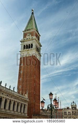 Close view of St Mark's Campanile St Theodore of Amasea statue and Biblioteca in Venice Italy. These buildings are the most recognizable symbols of the city.
