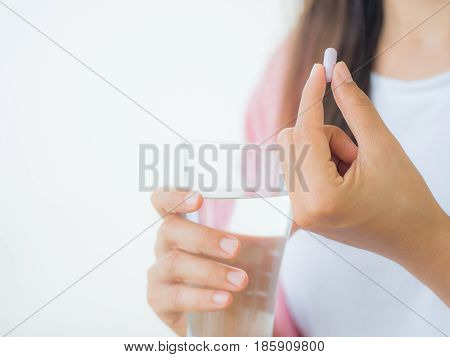 medicine health care and people concept - close up of woman taking in pill