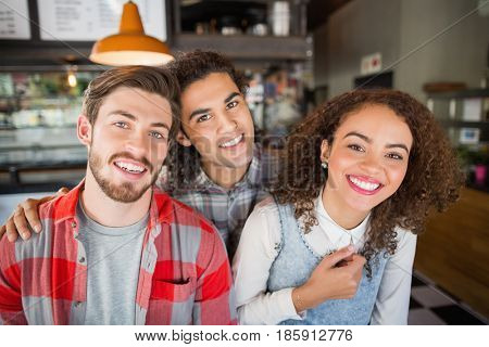 Portrait of smiling young friends in restaurant