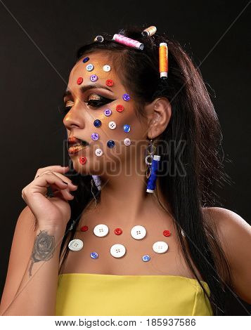 Young brunette with buttons on the front and papiotes in hair with yellow dress