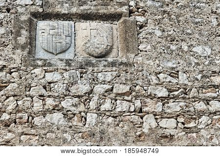 Coat of arms on the walls of the medieval fortress on the island of Rhodes
