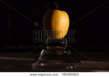 Yellow apples in a vase on a dark background. Beautiful apple.