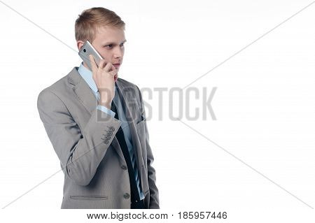 a young guy talking on the phone. in a business suit on a white background.
