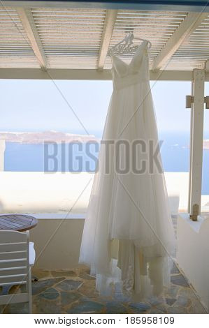 SANTORINI, GREECE - CIRCA AUGUST, 2015: wedding dress hanging in Andromeda Villas hotel. Andromeda Villas is a hotel are situated in Imerovigli, Santorini island.