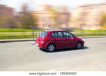 red minicar on city streets, high speed