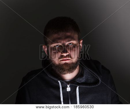Portrait of a man with a beard in the dark. Looking beauty.