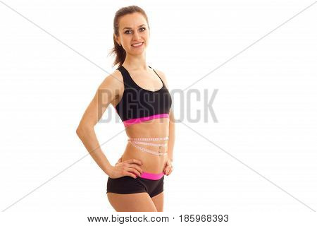 Slim beautiful girl in sports top smiling and posing for the camera isolated on white background
