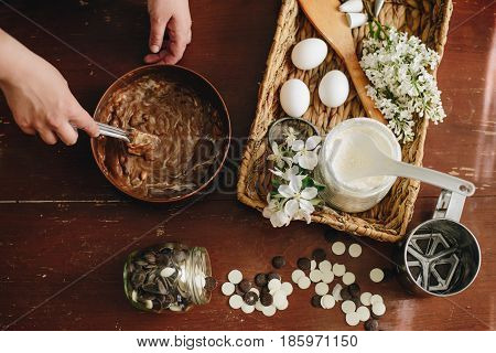 woman hands makeing cake on wooden background