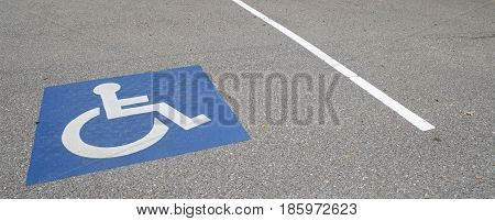 Handincapped designated parking space in a parking lot.
