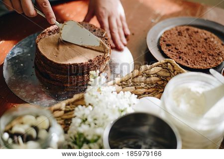 woman hands makeing cake on wooden background