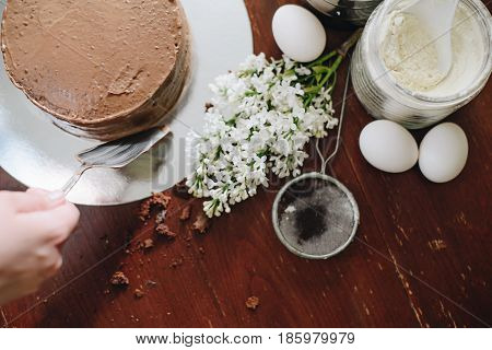woman hands makeing cake on wooden background