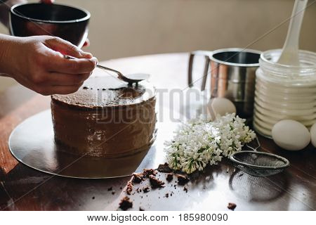woman hands makeing cake on wooden background