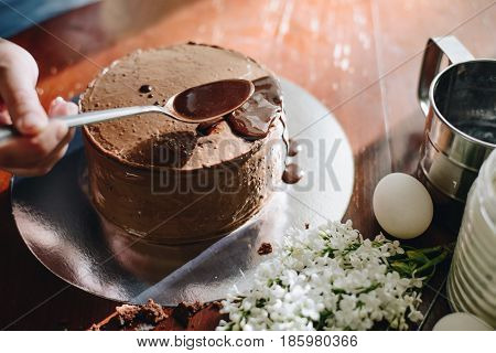 woman hands makeing cake on wooden background