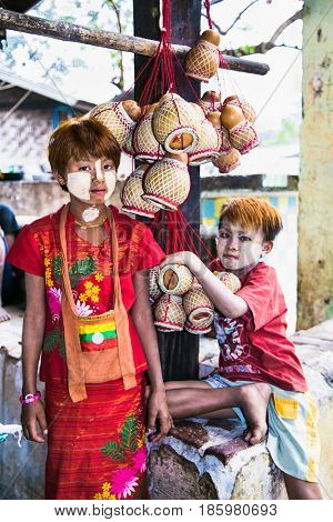 MIANDALAY,MYANMAR - MARC 6, 2017: Burmese children with thanaka on their face in Mandalay on March 6, 2017, Myanmar. Thanaka is a yellowish-white cosmetic paste made from ground bark