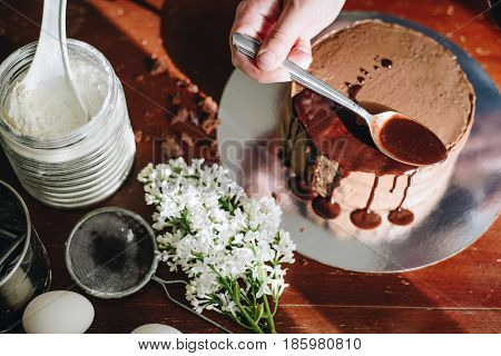 woman hands makeing cake on wooden background