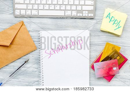 scolarship set with notebook, keyboard and cards on white desk background top view