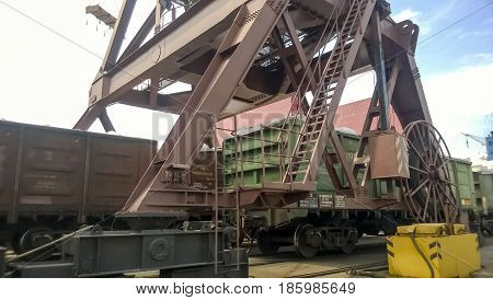 Loaded Freight Cars In The Port. Passage Of Cars Under The Tower