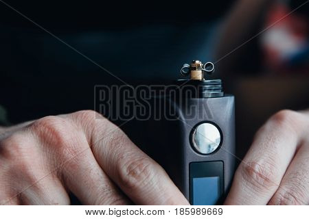 male master installs a coyle. Spiral for electronic evaporator and cigarette. Vape, vaping. Firing a coil.