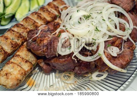 Cooked barbecue dish named shashlyk with onion rings