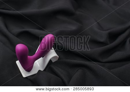 Enhance Your Sex Life. Close Up Of Silicone Prostate Massager On A Black Silk Fabric