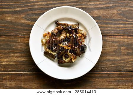 Fried Beef Liver With Onion On Plate Over Wooden Background. Pieces Cooked Liver (offal) From Beef. 