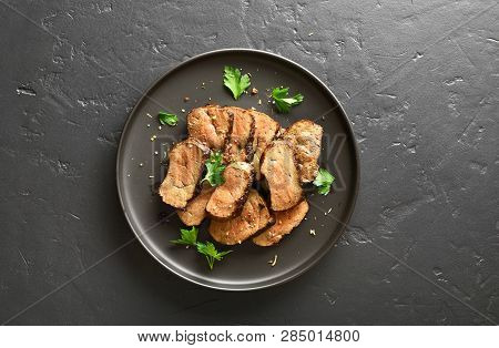 Grilled Beef Liver On Plate Over Black Stone Background. Cooked Liver(offal) From Beef Meat. Top Vie