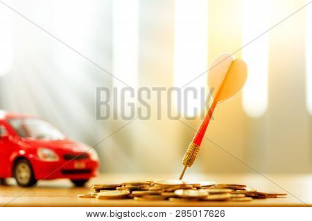 Red Arrow Embroidery On The Coin And Car Background Put On The Desk In The Office, Targeting Of Busi