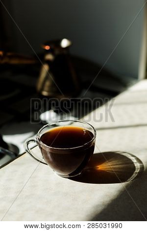 Black Coffee On The Breakfast In The Morning. Glass Cup And Sunny Weather.
