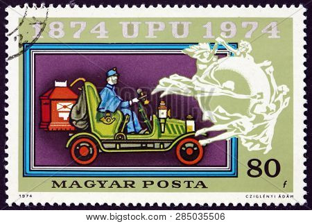 Hungary - Circa 1974: A Stamp Printed In Hungary Shows Old Mail Automobile, Upu Emblem, Centenary Of